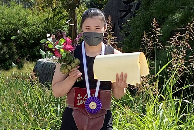 第26回全日本女子相撲選手権で優勝し、メダルを首からかけて笑顔の松本さん