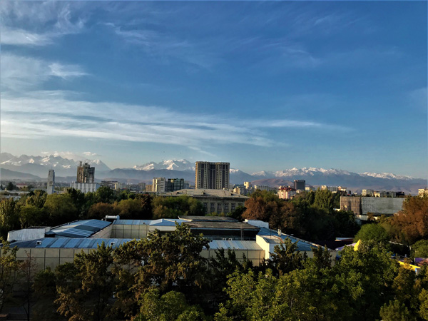 写真1：ホテルからの眺め。高層マンションの背後に天山の峰々を望む