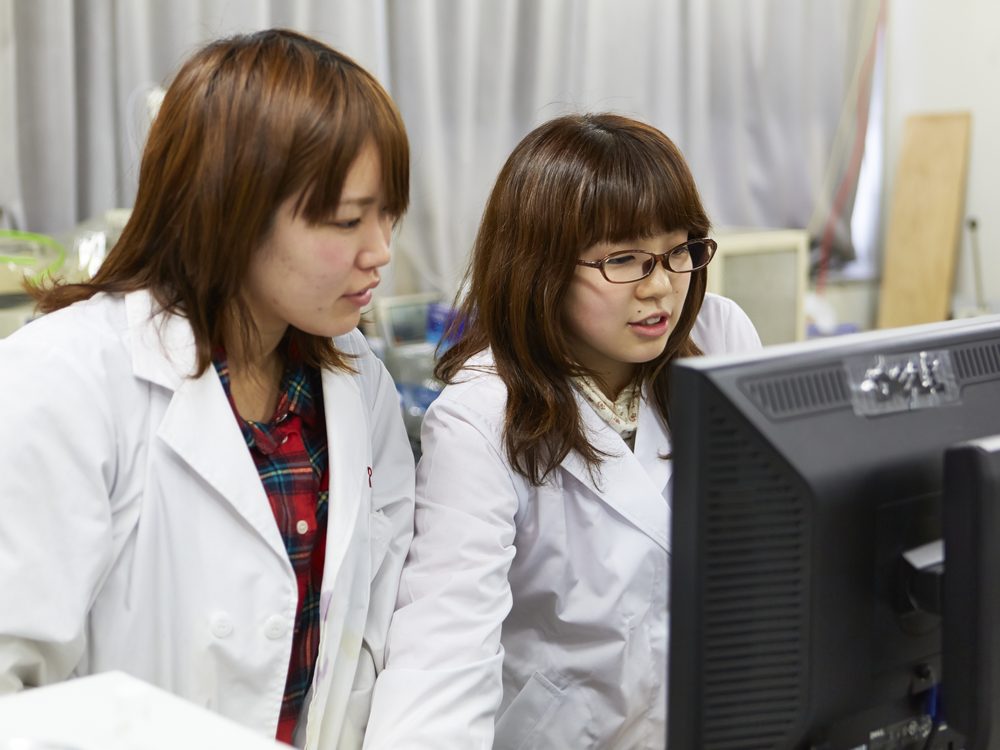 Two students checking measurement data