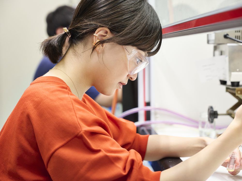 A student handling a sample