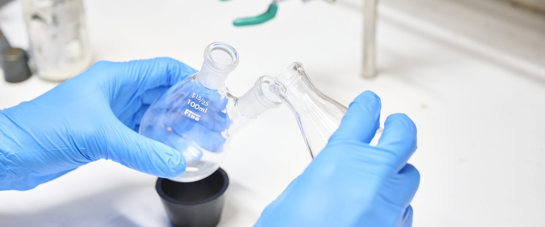 Hands handling a flask